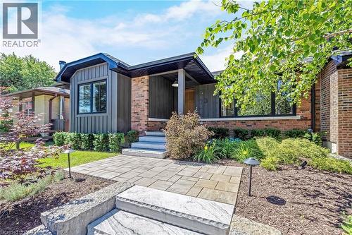 Contemporary facade featuring brick and vertical siding - 23 Mackenzie Drive, Georgetown, ON 