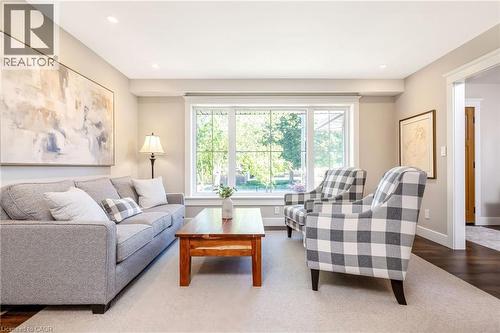 Spacious interior featuring a large picture window, recessed lighting, wood-finish flooring, and light neutral wall colors - 23 Mackenzie Drive, Georgetown, ON 