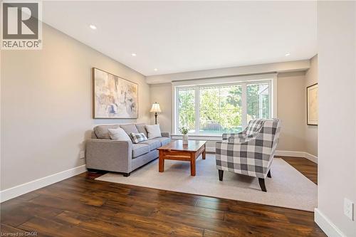 Living area featuring rich wood-finish flooring and recessed ceiling lighting - 23 Mackenzie Drive, Georgetown, ON 