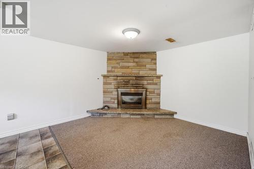 Stone-clad fireplace with a stainless steel insert - 14 Gateway Drive, Guelph, ON 