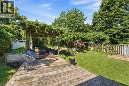 Expansive wooden deck leading to a covered pergola area - 14 Gateway Drive, Guelph, ON 