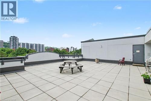 Expansive rooftop deck featuring large format square pavers and partial perimeter walls - 175 Hunter Street E Unit# 401, Hamilton, ON - Outdoor