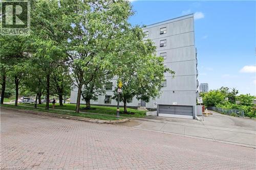Multi-story building featuring a light-colored exterior and multiple windows - 175 Hunter Street E Unit# 401, Hamilton, ON - Outdoor