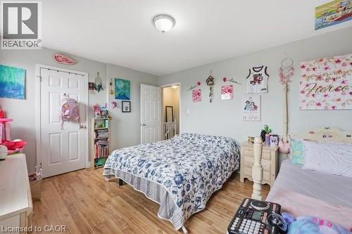 Spacious interior with wood-finish flooring, light gray walls, and white trim - 16 Harrison Avenue, Hamilton, ON 