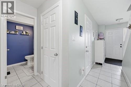 Entryway with white tile flooring and light gray walls - 16 Harrison Avenue, Hamilton, ON 