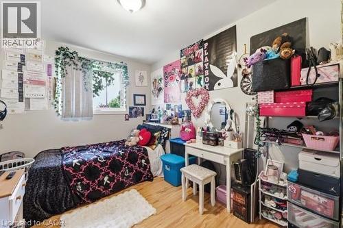 Bright room featuring light-toned walls and wood-finish flooring - 16 Harrison Avenue, Hamilton, ON 