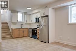 Kitchen with appliances with stainless steel finishes, light wood-style flooring, healthy amount of natural light, and light countertops - 