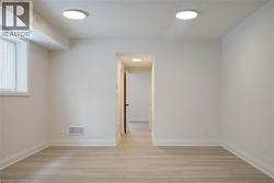 Unfurnished room with light wood-style floors and baseboards - 