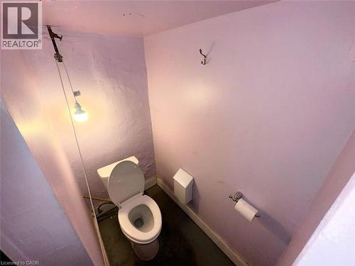 Pedestal toilet with a wall-mounted toilet paper holder - 318 James Street N, Hamilton, ON 
