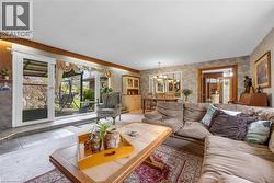 Living area with double French doors opening to an outdoor patio - 