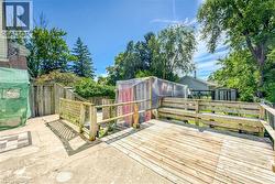 Expansive wooden deck with a built-in bench, offering a spacious outdoor area - 