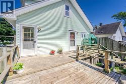 Exterior featuring light green horizontal siding and white trim - 