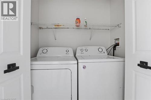 Dedicated laundry closet featuring a top-load washer and front-load dryer - 43 Decaro Crescent, Cambridge, ON 