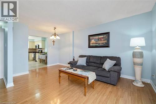 Light wood-finish flooring complements the pale blue walls and white trim - 121 Morgan Avenue Unit# 7, Kitchener, ON 