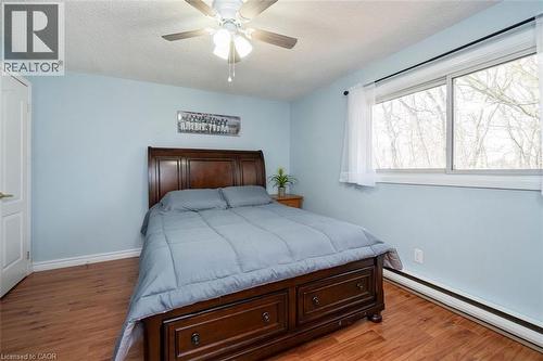 Bright room featuring wood-finish flooring, light blue wall paint, a ceiling fan, and white trim - 121 Morgan Avenue Unit# 7, Kitchener, ON 
