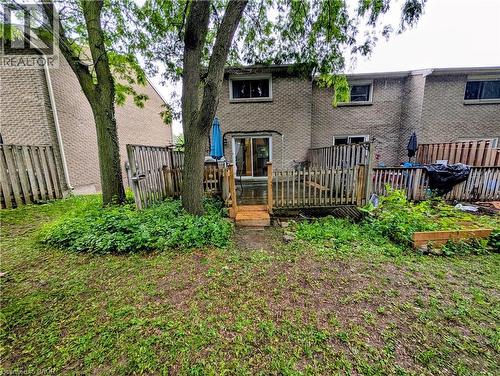 Rear yard with a multi-level wood deck and slider door access - 121 Morgan Avenue Unit# 7, Kitchener, ON 