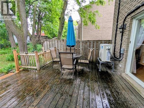 Expansive wood deck with a privacy fence and mature trees - 121 Morgan Avenue Unit# 7, Kitchener, ON 