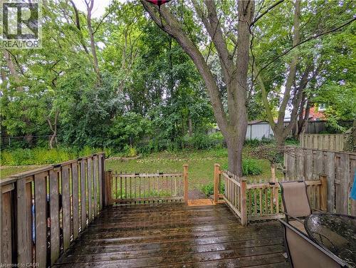 Expansive wood deck with full balustrade, featuring a gated entry to a large grass yard - 121 Morgan Avenue Unit# 7, Kitchener, ON 