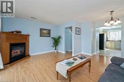 Living area featuring a corner fireplace with wood surround and mantle - 