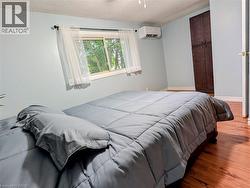 Spacious room featuring wood-finish flooring and light blue walls - 