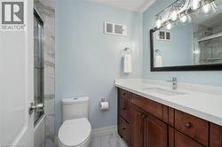 Contemporary bathroom featuring a dark wood-finish vanity with a white countertop and undermount sink - 