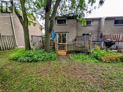 Rear yard with a multi-level wood deck and slider door access - 