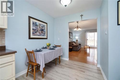 Dining area featuring wood-finish flooring, light blue walls, and a recessed ceiling light - 121 Morgan Avenue Unit# 7, Kitchener, ON 
