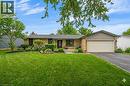 Ranch-style residence featuring a brick facade, a two-car garage, and a charcoal shingle roof - 44 Mcclellan Road, Alton, ON 
