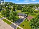 Single-story residence featuring a dark shingle roof, attached garage, and a paved driveway - 44 Mcclellan Road, Alton, ON 