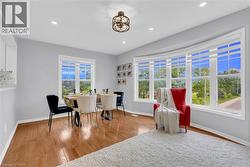Bright interior featuring wood-finish flooring and a curved bay window - 
