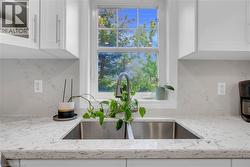 Kitchen features a double basin stainless steel sink with a gooseneck faucet - 