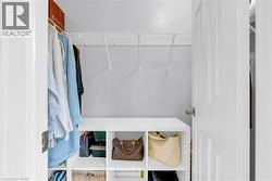 White wire shelving system, wall-mounted hanging rods, and built-in cubby storage - 