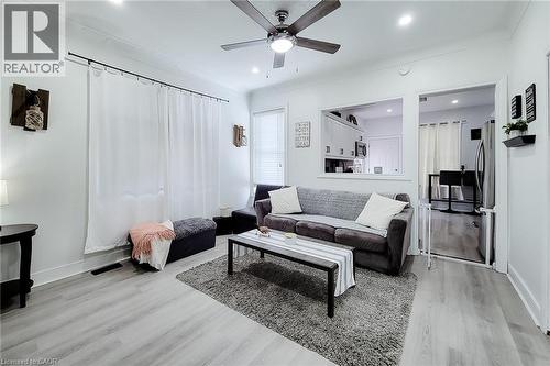Open-concept living area featuring light wood-finish flooring, recessed lighting, and a ceiling fan - 58 East 22Nd Street, Hamilton, ON 