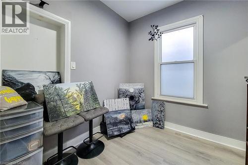 Room featuring light gray walls, white trim, and wood-finish flooring - 58 East 22Nd Street, Hamilton, ON 