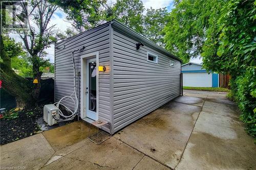 Detached accessory structure with horizontal siding and a side-entry door - 58 East 22Nd Street, Hamilton, ON 