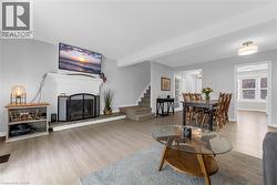 Open-concept living area with a built-in fireplace featuring a stone hearth - 