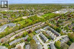 Aerial perspective showcasing a residential area with varied housing structures, including townhomes and multi-unit buildings - 