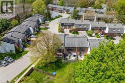 Aerial perspective showcasing multiple townhome units with gabled roofs and brick facades - 