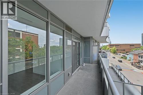 Private outdoor balcony featuring a concrete floor and a contemporary railing with glass panels - 212 King William Street Unit# 418, Hamilton, ON 