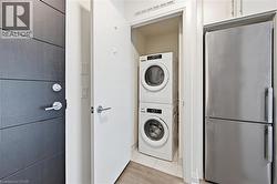 Compact laundry closet featuring a stacked washer and dryer - 