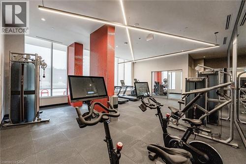 Fitness room featuring rubber flooring, floor-to-ceiling windows, and recessed linear lighting - 212 King William Street Unit# 418, Hamilton, ON 