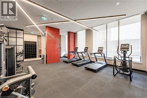 Contemporary fitness center featuring high ceilings with linear lighting, expansive windows with roller shades, and durable tiled flooring - 212 King William Street Unit# 418, Hamilton, ON 