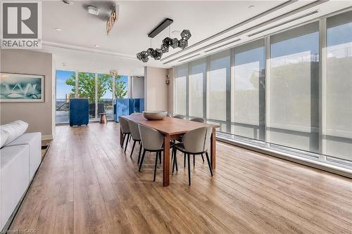 Open-concept room featuring wood-finish flooring, recessed lighting, and a modern geometric pendant light fixture - 212 King William Street Unit# 418, Hamilton, ON 