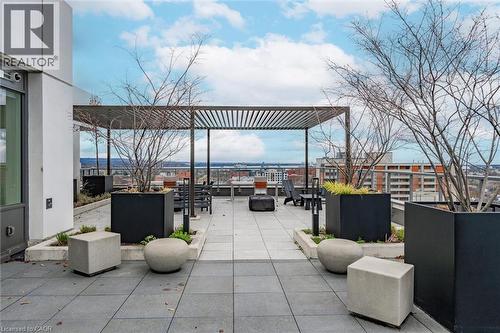 Expansive rooftop patio featuring a slatted pergola structure - 212 King William Street Unit# 418, Hamilton, ON 