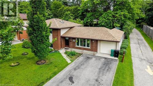 Brick and siding exterior featuring a multi-level roofline - 619 Forest Hill Drive, Kitchener, ON 