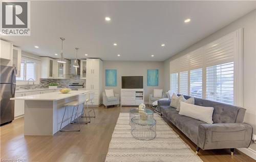 Open-concept living space featuring wood-finish flooring throughout - 619 Forest Hill Drive, Kitchener, ON 