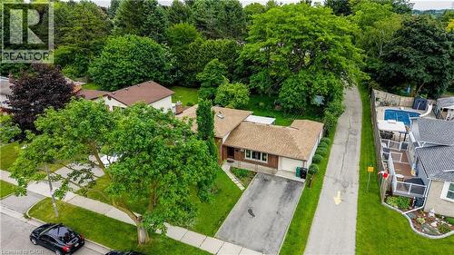 Split-level residence featuring a brown shingle roof, brick and siding exterior, and an attached two-car garage - 619 Forest Hill Drive, Kitchener, ON 