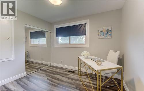 Room featuring wood-finish flooring, light grey walls, and white trim - 619 Forest Hill Drive, Kitchener, ON 
