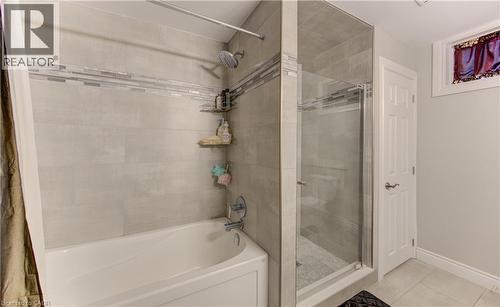 Bathroom featuring a combination bathtub and walk-in shower with glass enclosure - 619 Forest Hill Drive, Kitchener, ON 