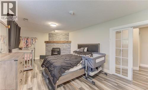 Interior space featuring a stacked stone fireplace surround with a wood mantel - 619 Forest Hill Drive, Kitchener, ON 